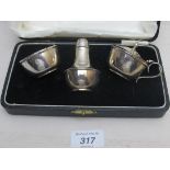 A three piece silver condiment set, comprising of salt, pepper and mustard, boxed,