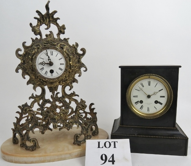 An ornate Rococo-style gilt-metal cased mantel clock, marbled base,