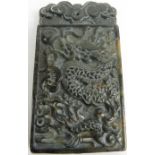 Jade pendant with carved dragon in relie