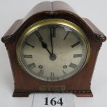 A 1920's/30's walnut cased striking mantel clock, the Empire movement striking on a gong,