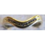 An 18ct gold eleven diamond set V shaped ring,