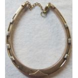 A 9ct gold horse shoe shaped bracelet wi