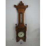 A Victorian 'Aesthetic Period' light oak wall aneroid barometer,