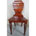 A Victorian mahogany hall chair with an ornate carved back and in clean condition est: £40-£60