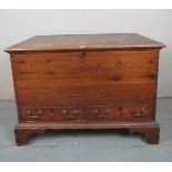 An early 19th Century pine mule chest with a lift up lid to top over a long frieze drawers and