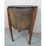 A large and very decorative copper log bin mounted on a wooden frame with four legs est: £150-£250
