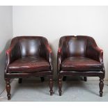 A pair of 20th Century leather library club chairs upholstered in burgundy leather and in good