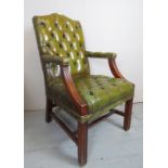 A 20th Century green deep buttoned leather desk chair with mahogany show wood est: £80-£120