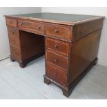 A fine 19th Century mahogany pedestal partners desk with an inset green leather top over nine cross