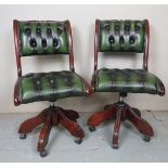 A pair of late 20th Century deep buttoned green leather swivel desk chairs in good condition (fit