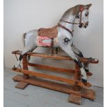 A late 19th / early 20th Century grey dapple rocking horse bearing a label for 'Mettam & Lewis,