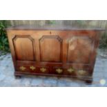 An 18th Century oak mule chest with a lift up lid over three panels to front and two drawers