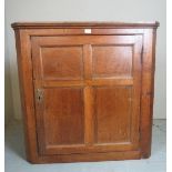 A 19c oak corner cupboard with panelled