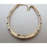 A 9ct gold horse shoe shaped bracelet wi