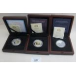 A collection of three silver £5 proof co