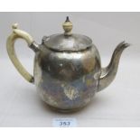 An unmarked teapot with ivory handle and