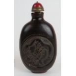 A Chinese carved snuff bottle with a dra