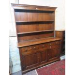 A solid oak kitchen dresser with plate r