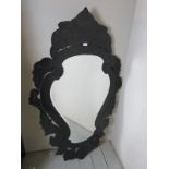 A large contemporary carved black framed