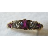 An 18ct gold three stone ruby and diamon