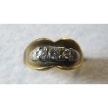 An 18ct gold three stone diamond set rin
