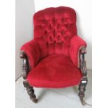 A Victorian armchair upholstered in deep