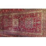 A 20th century Persian rug on red ground