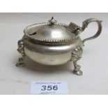 A heavy silver circular mustard pot with