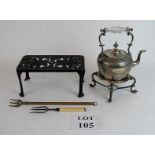 A silver plated kettle on warming stand