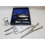 A part silver manicure set, Birmingham 1918, boxed, a pair of silver handled glove stretchers,