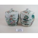 A pair of Chinese jars with lids decorated in Famille vert enamels with rural landscapes,