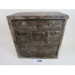 A 17th/18th century oak nest of drawers, possibly for spice, door missing,