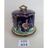 A large Majolica cheese dish and cover, decorated with herons on a blue ground,