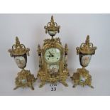 A decorative modern French gilt-metal and porcelain three piece clock garniture in the 19th century