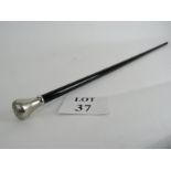 A black lacquered cane with silver coloured top and brass ferule,