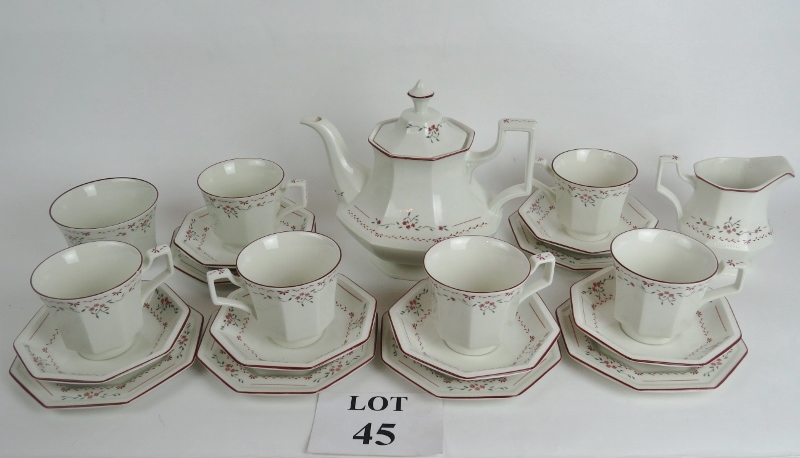 A good quality tea set of octagonal shape with a floral pattern on a pale cream ground,