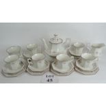 A good quality tea set of octagonal shape with a floral pattern on a pale cream ground,