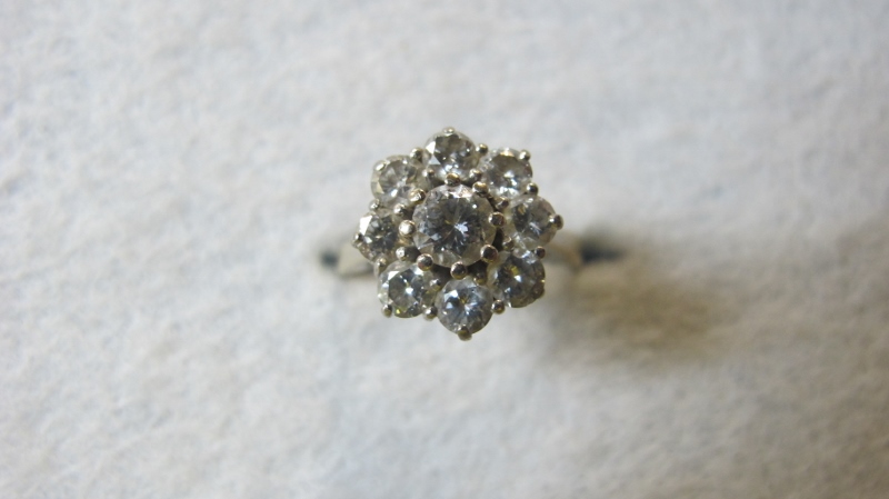 An 18ct gold diamond cluster ring, set with nine brilliant cut diamonds, 1.23cts, total weight 3.