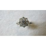 An 18ct gold diamond cluster ring, set with nine brilliant cut diamonds, 1.23cts, total weight 3.
