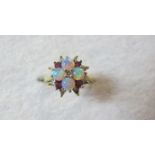 An 18ct gold opal, diamond and ruby ring,