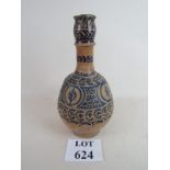 An Islamic vase with stylised blue decorative pattern on a sienna ground, glazed in places,