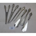 A collection of five silver handled shoe horns and button hooks,