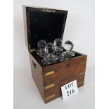 A good quality Victorian brass bound figured walnut decanter box, containing four decanters,