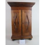 A late 19th/early 20th century hardwood table-top cigar cabinet, the twin doors stamped 'MI NECHA,