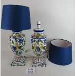 A pair of Faience table lamps in vibrant colours decorated with birds and foliage,