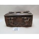 Carved wooden wine butler with space for three bottles, and with vine leaf decoration,