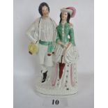 A large late 19th/early 20th century Staffordshire pottery figure group, male and female companion,