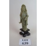 A carved Chinese figure of an elder in soapstone, on a wooden base,