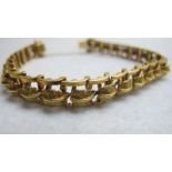 An 18ct gold bracelet having raised leaf design, with safety chain,