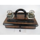 A Victorian walnut and part-ebonised desk-top writing stand, loop handle, two pen trays,